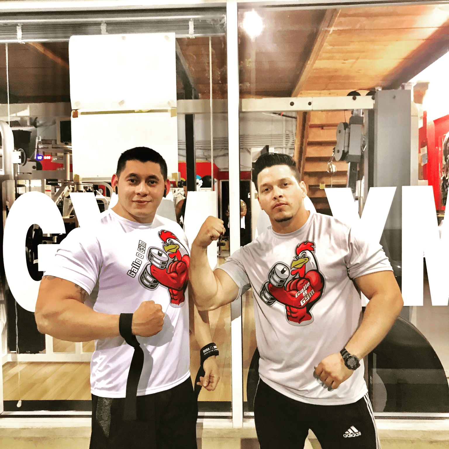 Two members flexing in Gallo 8 shirts
